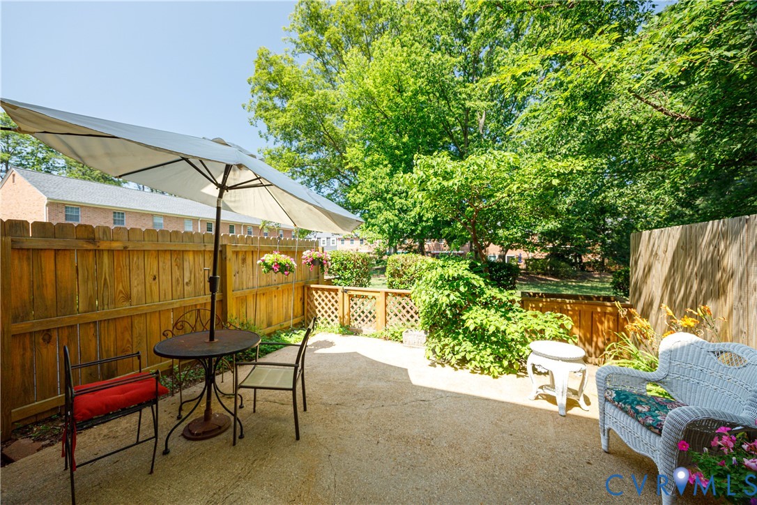 9129 Derbyshire Road, Unit E Henrico, VA 23229 - Photo 28 of 36 Private concrete patio featuring a wood privacy fe