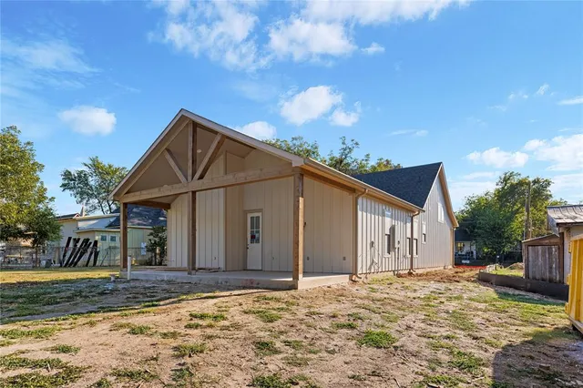 a view of a street sign under a large tree
