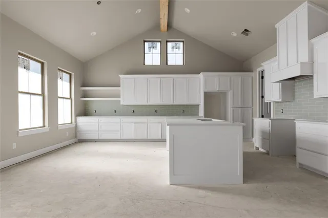 a bathroom with double vanity and a bathtub