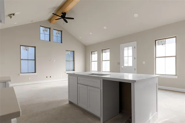 an empty room with windows and cabinet