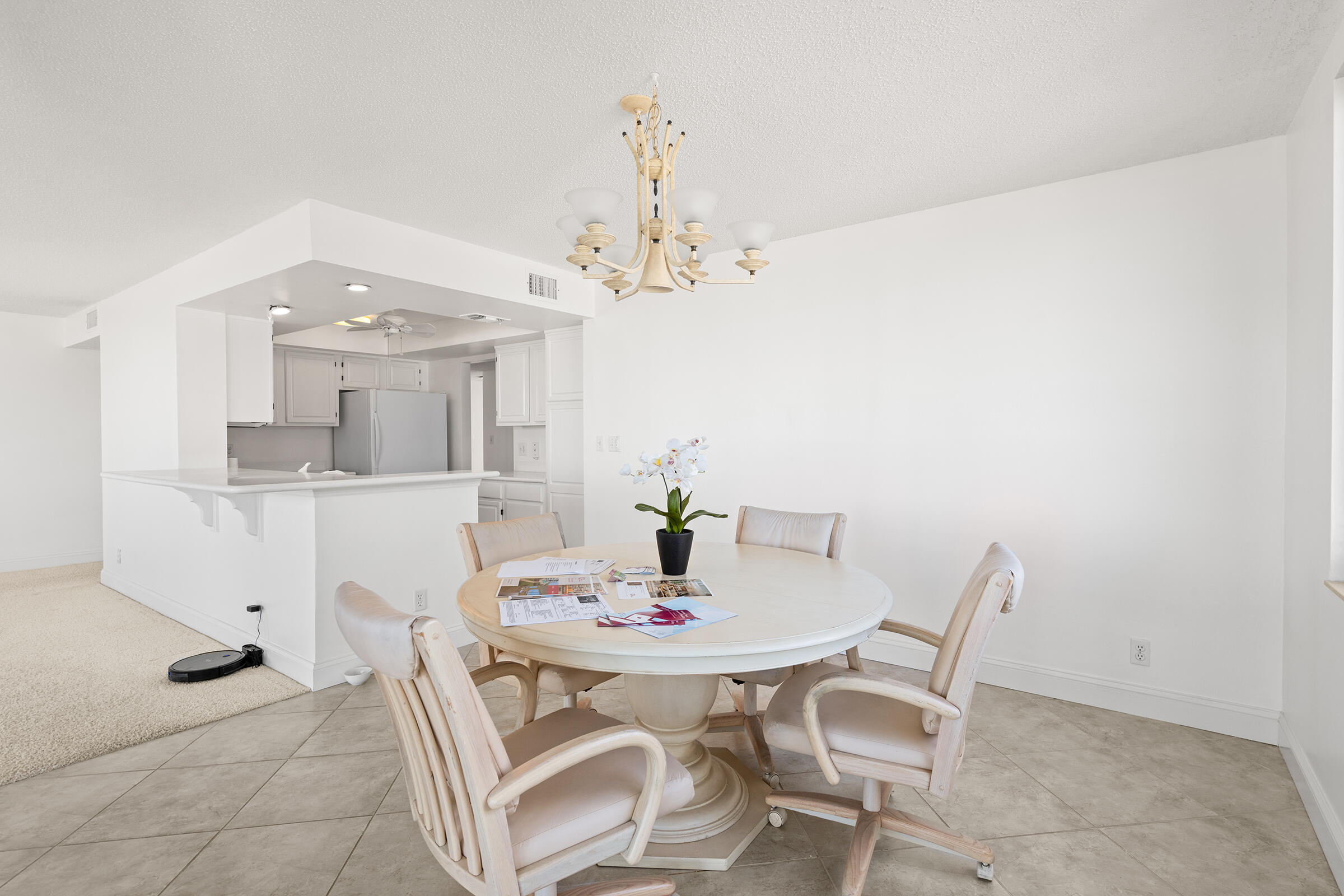 2375 Northeast Ocean Boulevard, Unit E103 Stuart, FL 34996 - Photo 13 of 49 a view of a dining room with furniture and chandelier