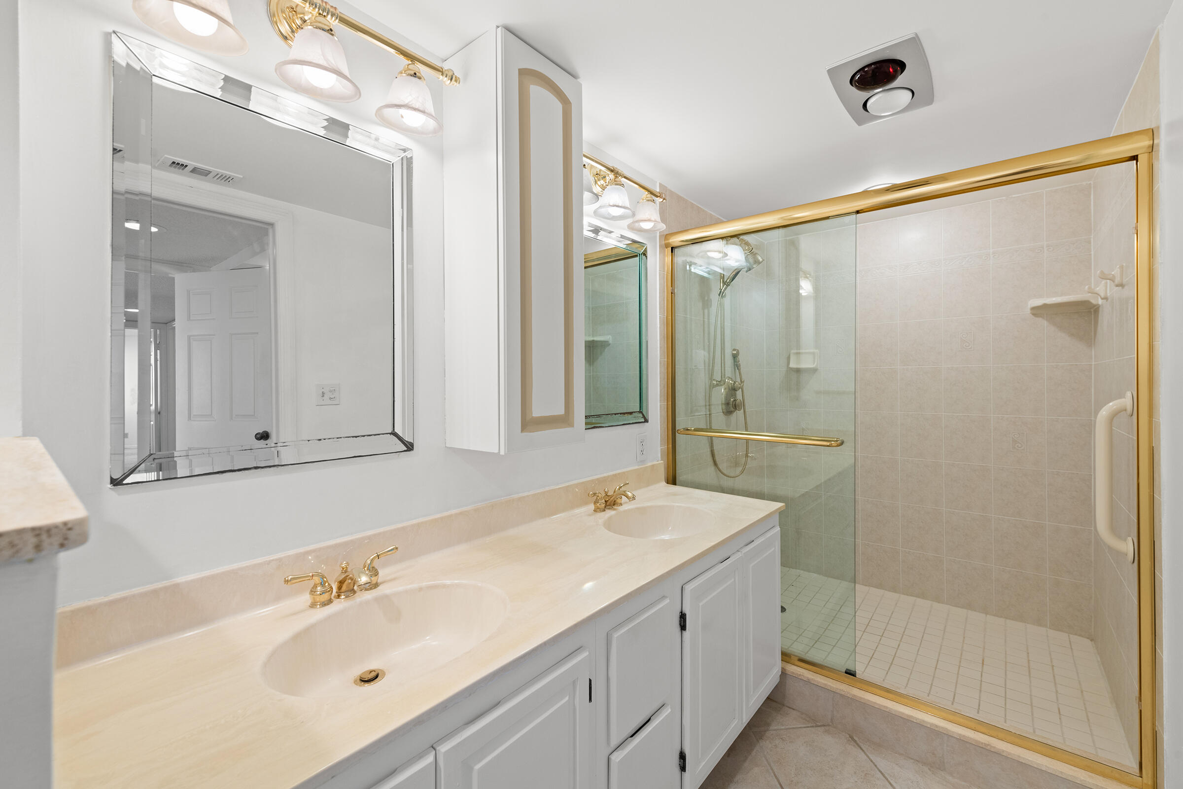 2375 Northeast Ocean Boulevard, Unit E103 Stuart, FL 34996 - Photo 14 of 49 a bathroom with a shower sink and mirror