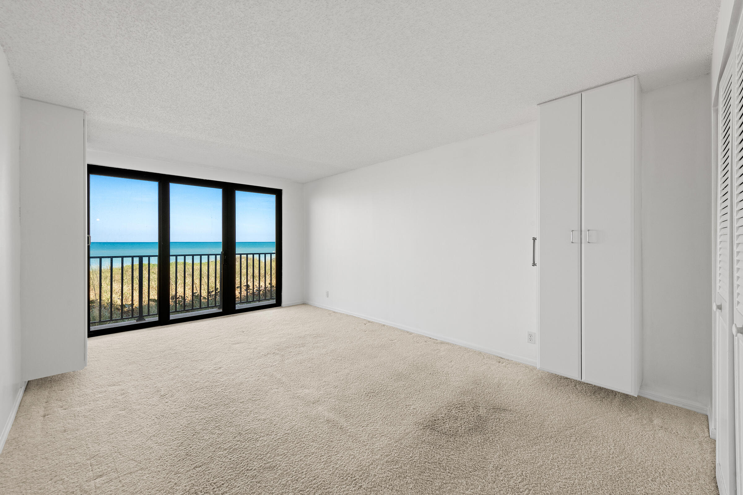 2375 Northeast Ocean Boulevard, Unit E103 Stuart, FL 34996 - Photo 20 of 49 a view of an empty room with a balcony