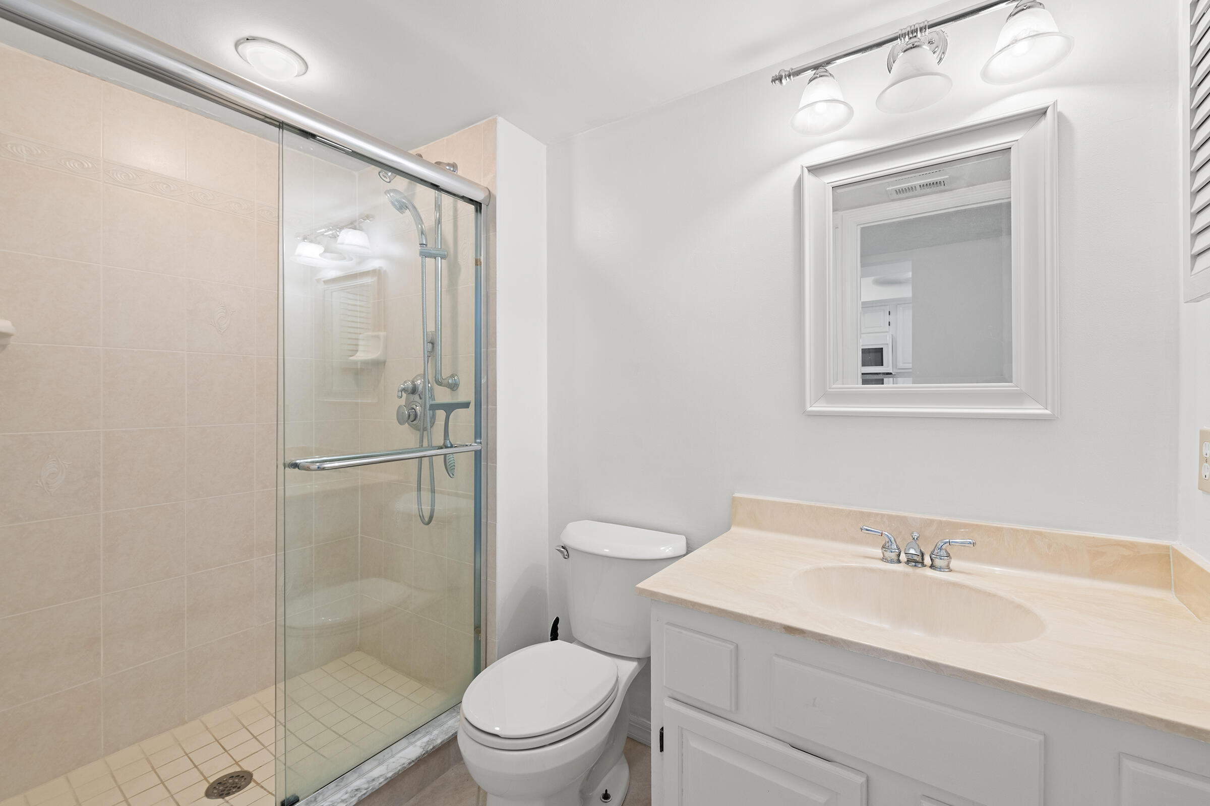 2375 Northeast Ocean Boulevard, Unit E103 Stuart, FL 34996 - Photo 29 of 49 a bathroom with a sink a toilet and shower