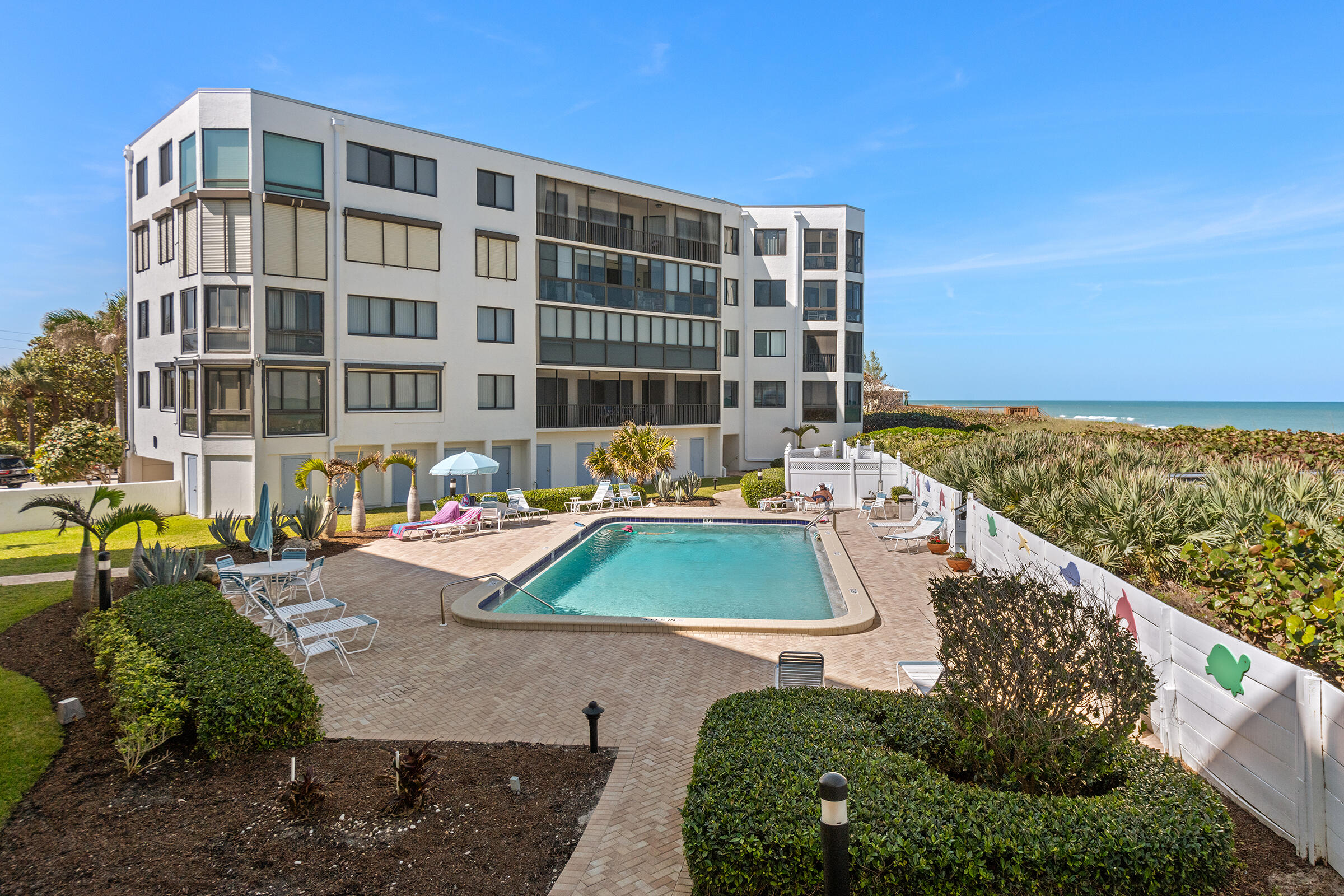 2375 Northeast Ocean Boulevard, Unit E103 Stuart, FL 34996 - Photo 36 of 49 a view of swimming pool with outdoor seating and plants