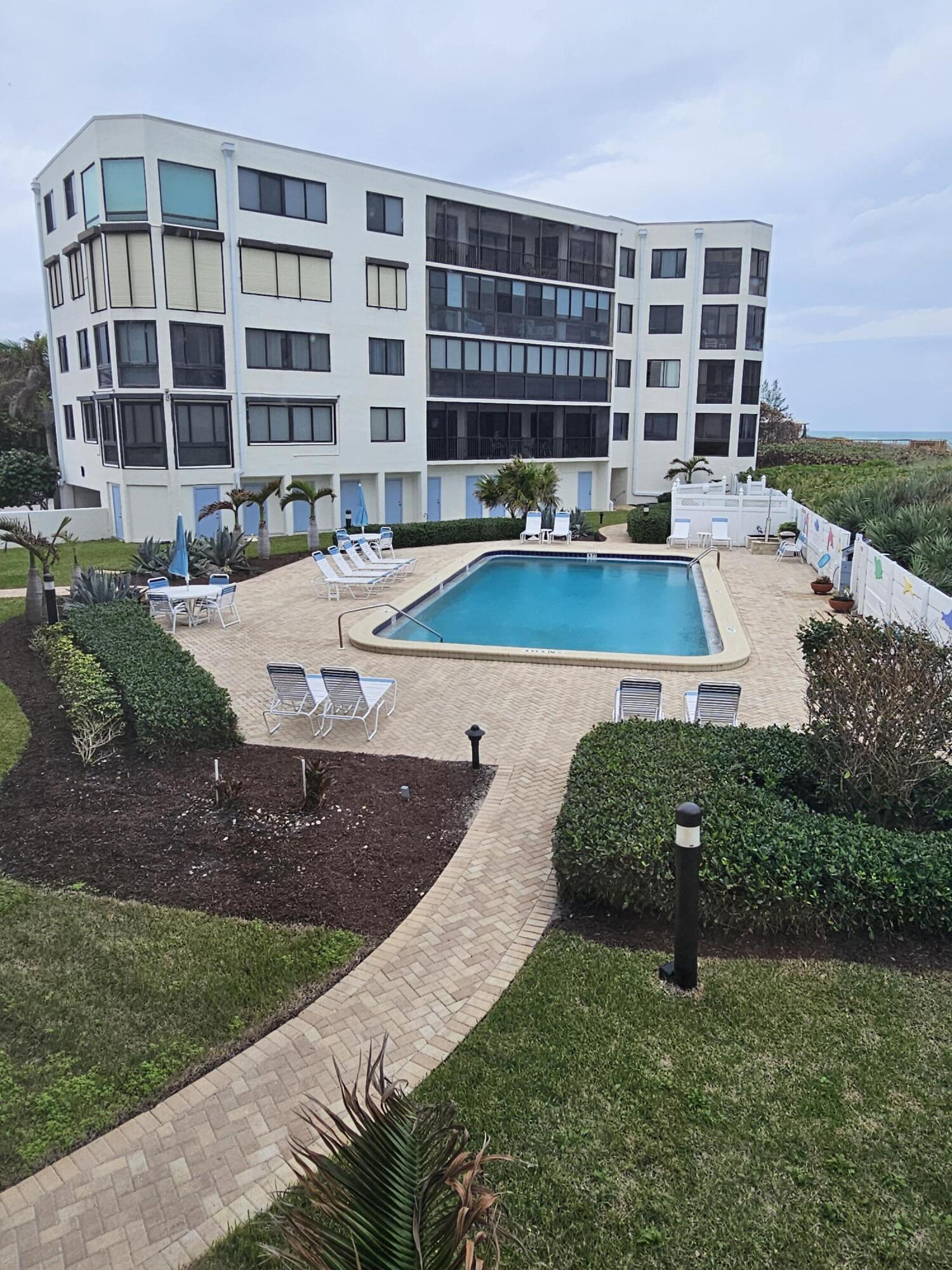 2375 Northeast Ocean Boulevard, Unit E103 Stuart, FL 34996 - Photo 41 of 49 a view of a swimming pool with a patio
