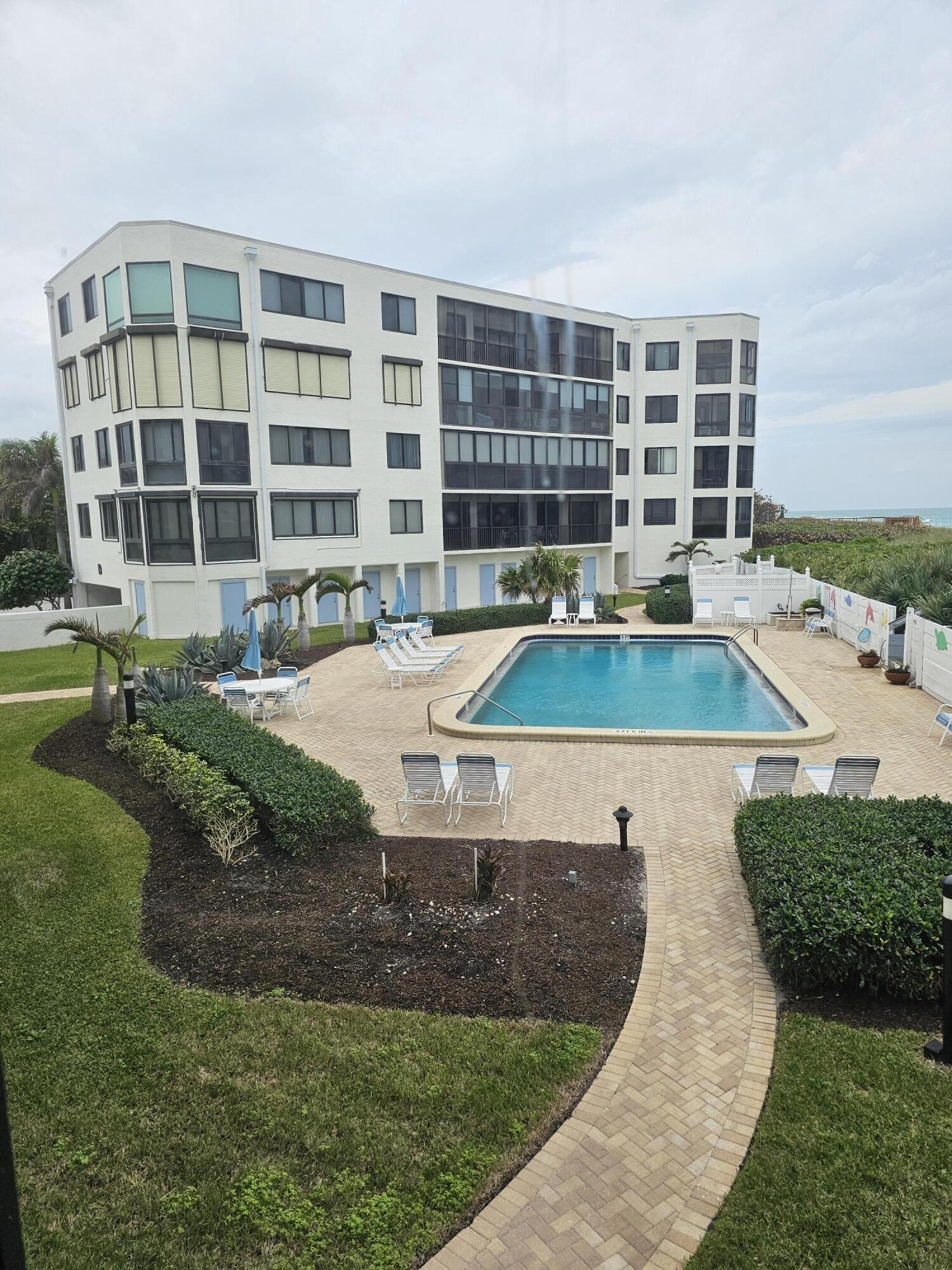 2375 Northeast Ocean Boulevard, Unit E103 Stuart, FL 34996 - Photo 48 of 49 a view of a swimming pool with outdoor seating