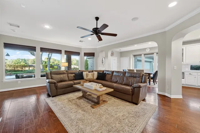 a living room with furniture a fireplace and a large window