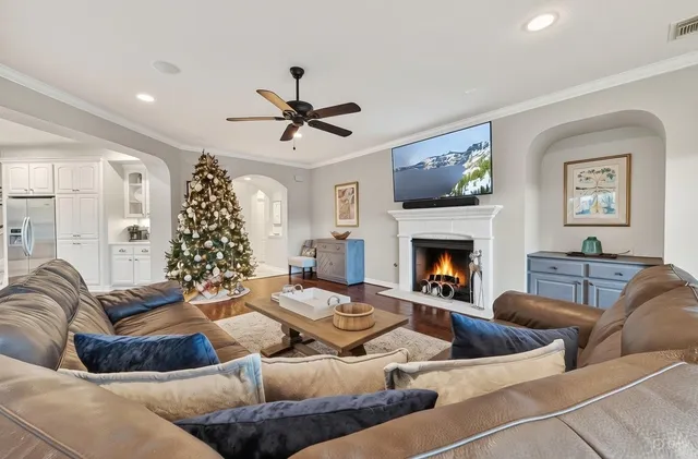 a living room with furniture a fireplace and a chandelier