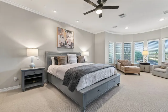 a living room with furniture and floor to ceiling windows