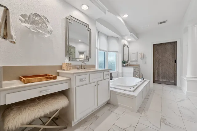 a spacious bathroom with a double vanity sink a mirror and shower