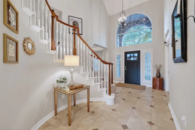 a view of a dining room with furniture a chandelier and wooden floor