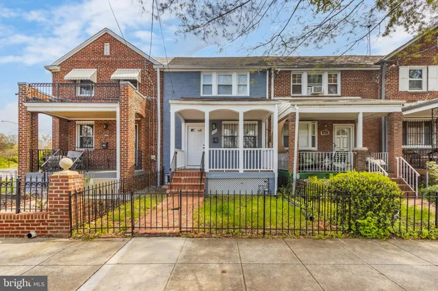 a view of a house with wooden fence