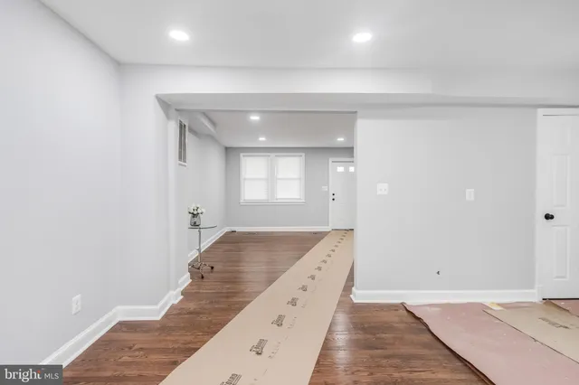 a spacious bathroom with a granite countertop sink and a mirror