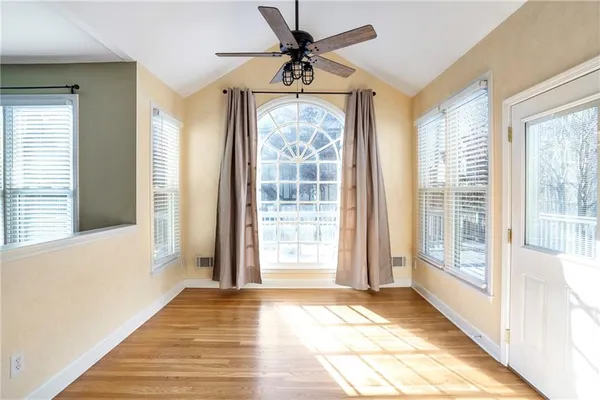 a view of an empty room with a fireplace and a window
