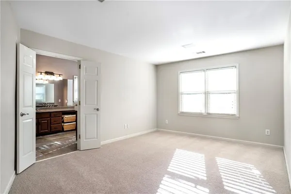 a spacious bathroom with sink bathtub and next to a window