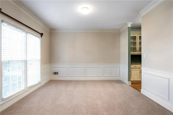 a large kitchen with granite countertop a stove a sink and dishwasher wooden cabinets with granite countertops