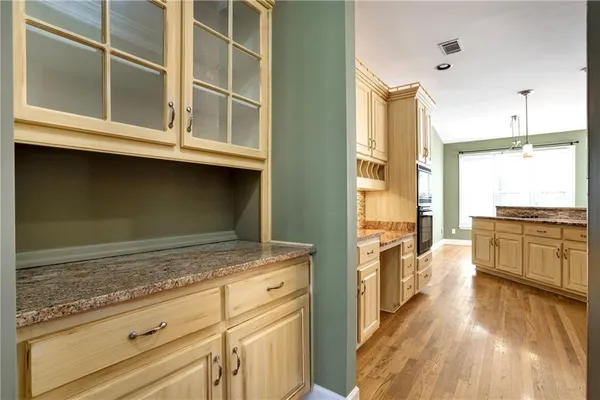 a kitchen with stainless steel appliances granite countertop a stove and a refrigerator