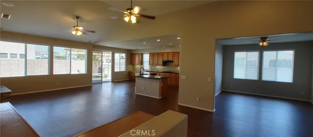 a view of a hallway with wooden floor and glass door