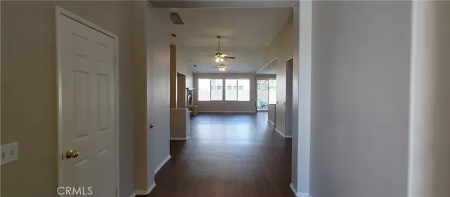 an empty room with wooden floor and a window