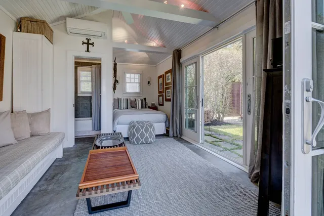 a bed room with a bed and a large window