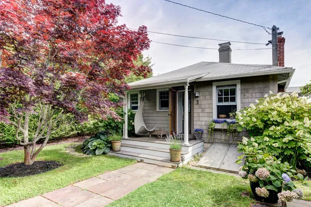 a front view of a house with a garden