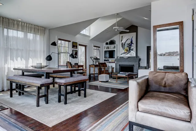 a living room with furniture fireplace and a window