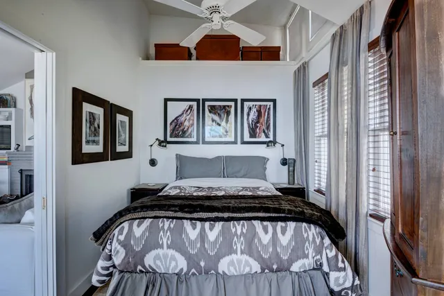 a bedroom with a bed and a painting on the wall