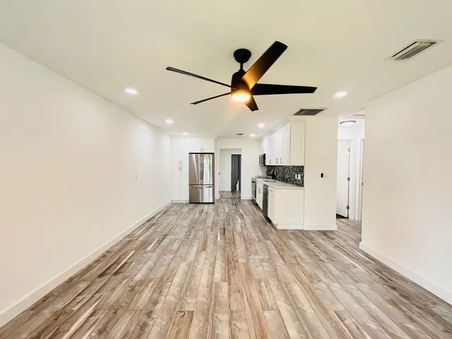 a view of a kitchen with a sink and wooden floor