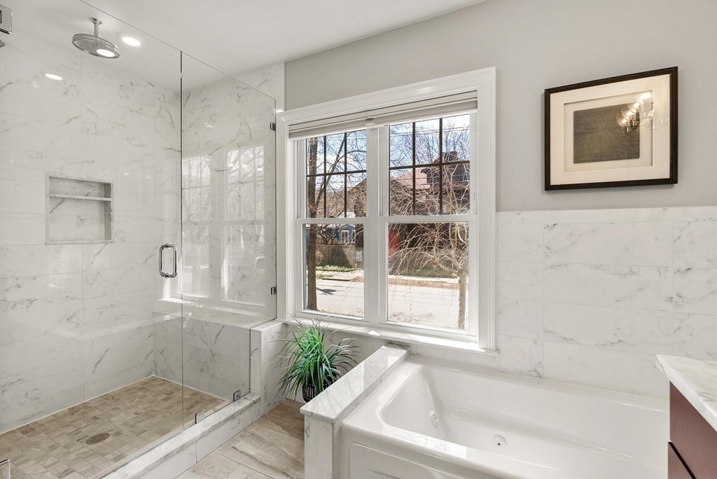 77 Beaconsfield Road, Unit 77 Brookline, MA 02445 - Photo 11 of 21 a bathroom with a tub shower and sink