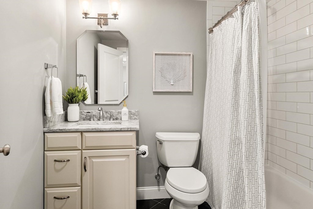 77 Beaconsfield Road, Unit 77 Brookline, MA 02445 - Photo 13 of 21 a bathroom with a toilet a sink and a mirror