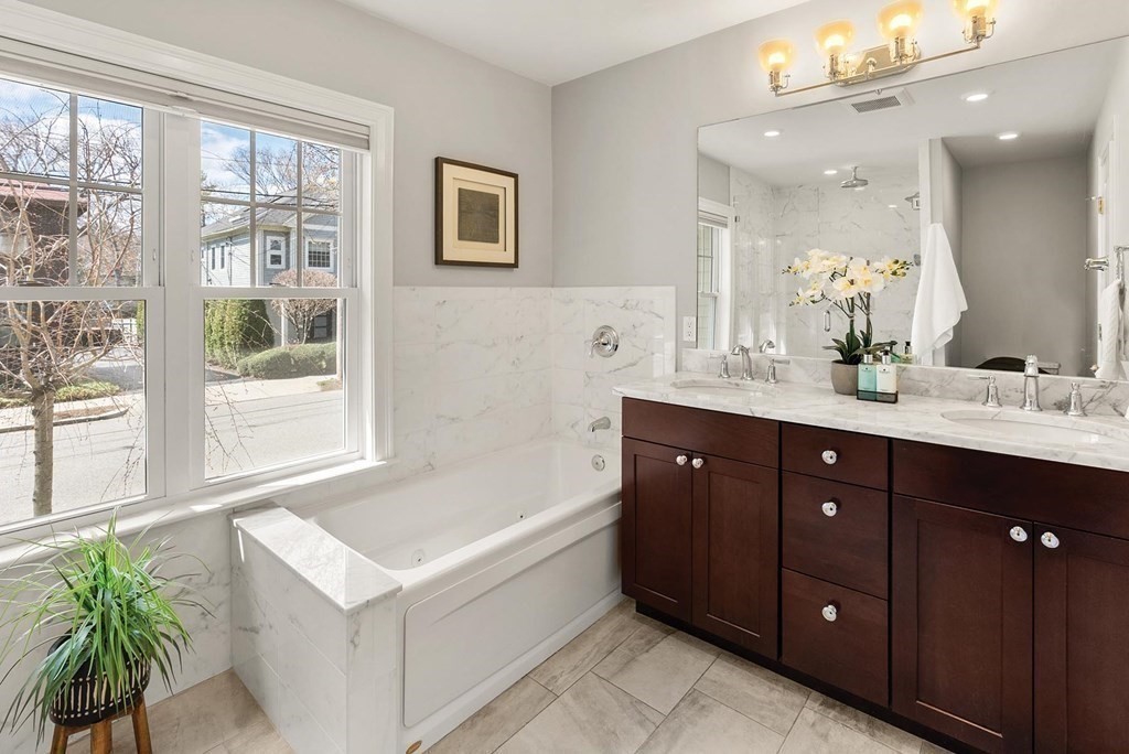 77 Beaconsfield Road, Unit 77 Brookline, MA 02445 - Photo 10 of 21 a spacious bathroom with a tub sink and mirror