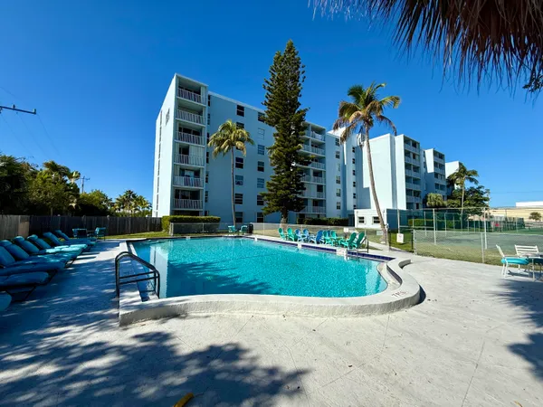 a swimming pool with outdoor seating and yard
