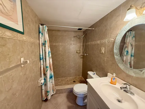 a bathroom with a sink toilet and shower