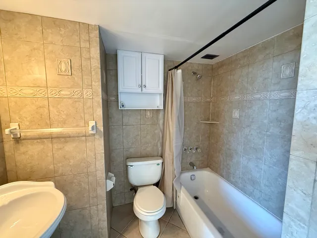 a bathroom with a toilet and shower