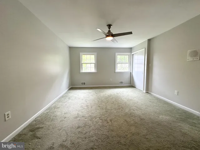 a bathroom with a double vanity sink toilet and a mirror
