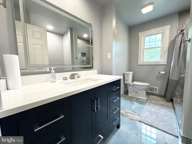 a bathroom with a toilet sink and shower