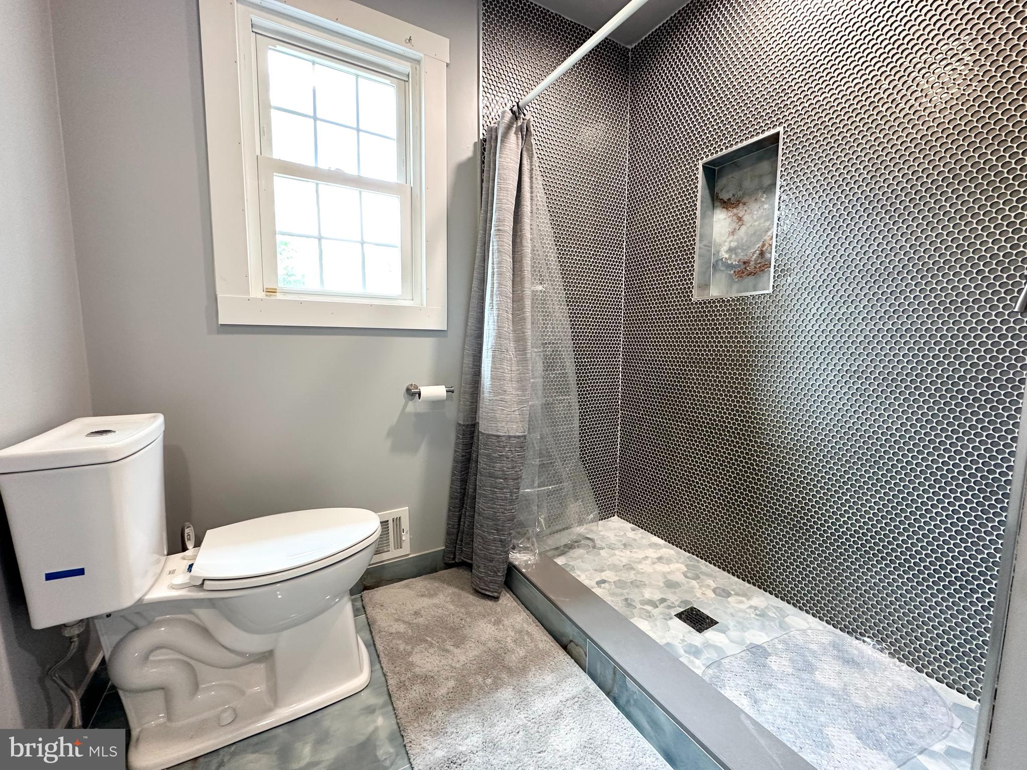 9805 Binyon Court Fort Washington, MD 20744 - Photo 17 of 25 a bathroom with a toilet sink and shower