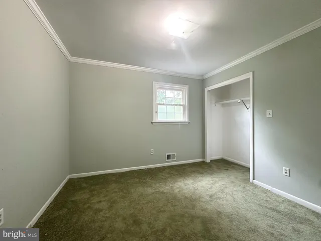 a room with pool table and windows