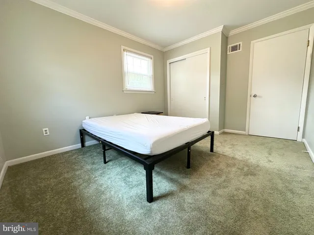 a bathroom with a granite countertop toilet sink and mirror