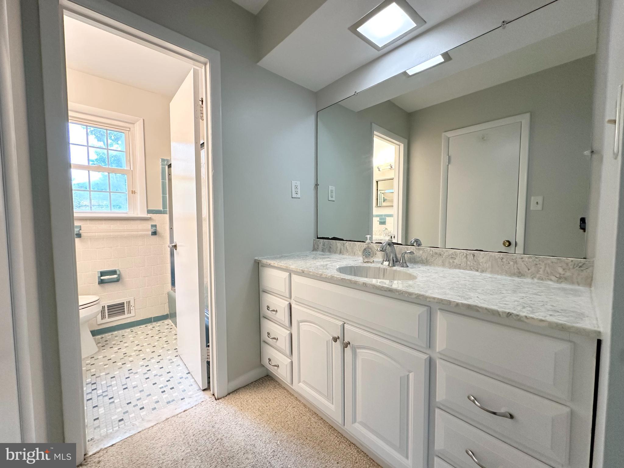 9805 Binyon Court Fort Washington, MD 20744 - Photo 24 of 25 a bathroom with a granite countertop sink and a mirror