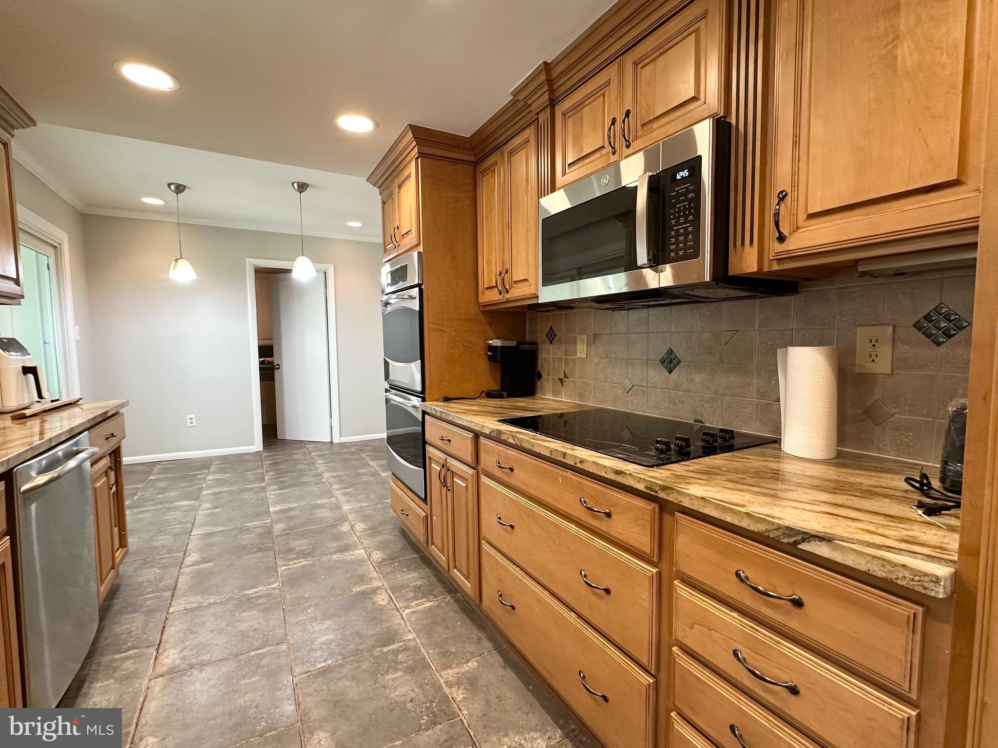 9805 Binyon Court Fort Washington, MD 20744 - Photo 8 of 25 a kitchen with stainless steel appliances granite countertop a stove and a microwave