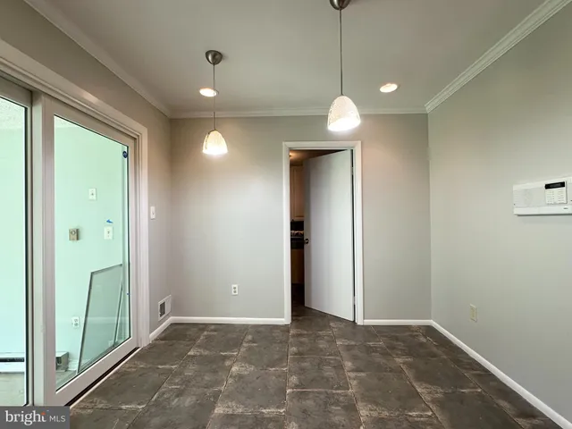 a view of an empty room and fire place