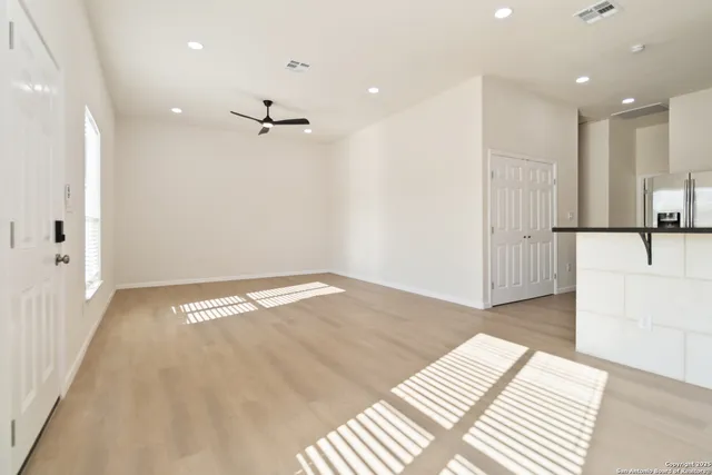 a view of a kitchen with a refrigerator and a sink