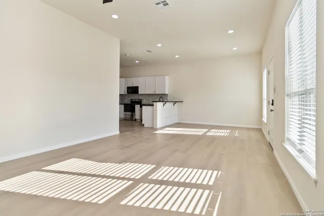a view of a kitchen with a sink and a window