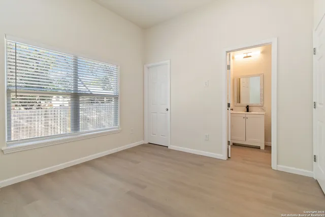 an empty room with a window and a bathroom