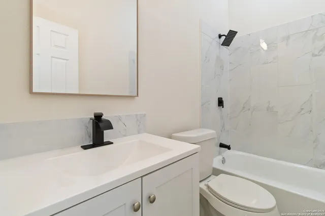 a bathroom with a sink a toilet and a bathtub