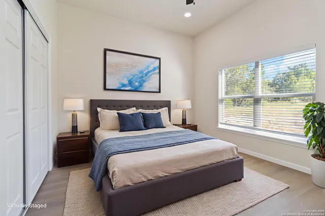 a bedroom with bed and a large window