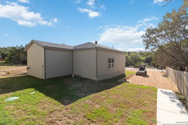 a view of a backyard with sitting area