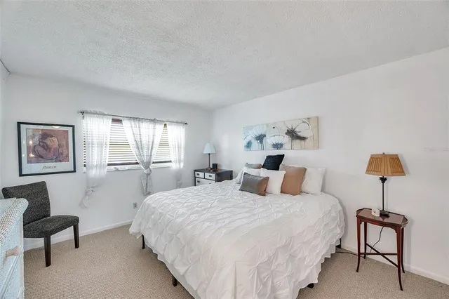 a bedroom with a bed and a television